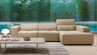 Seating area with a modern tan sectional sofa and wood coffee table.